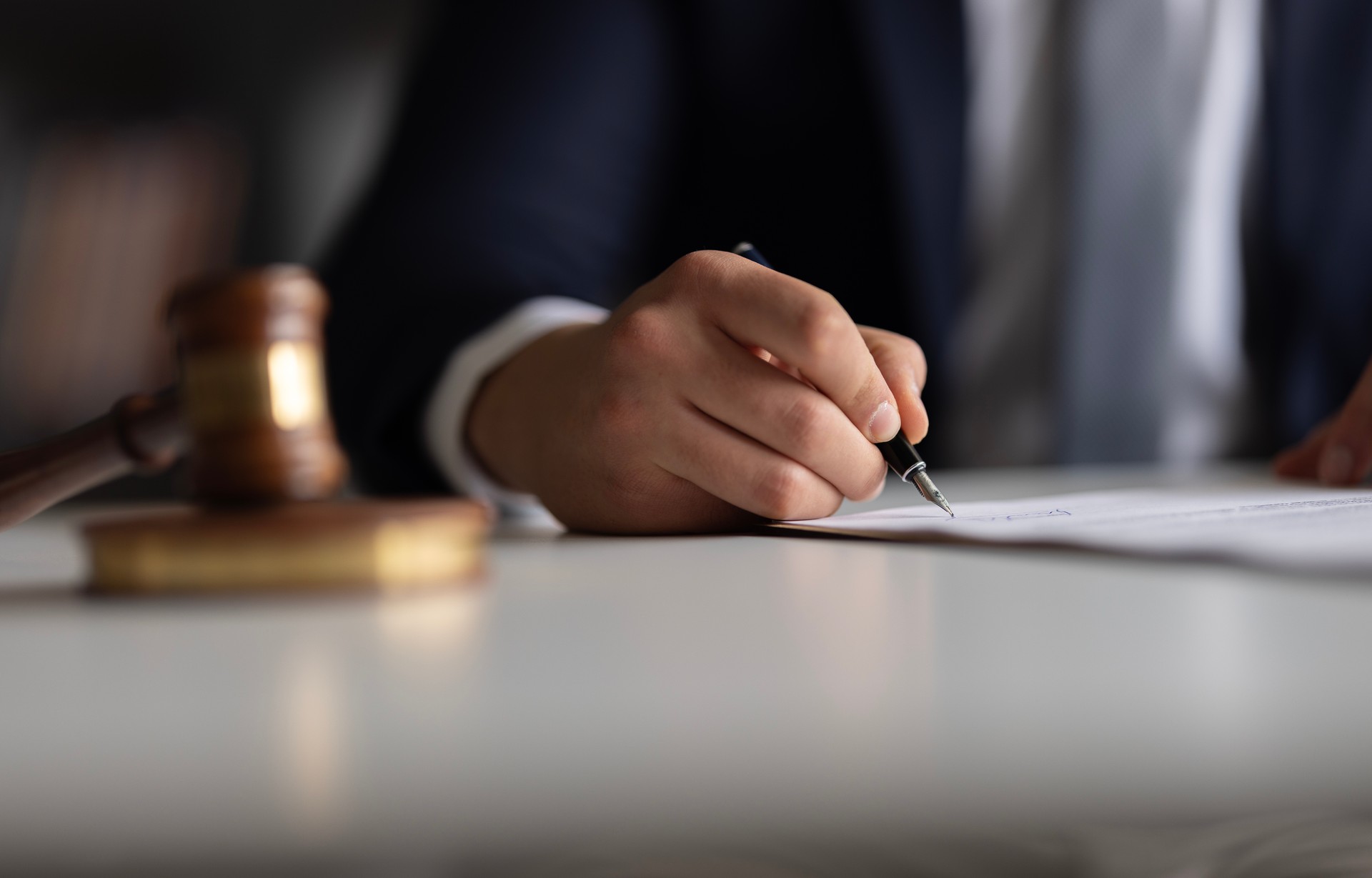 Judge or Legal advisor lawyer examining and signing legal documents.